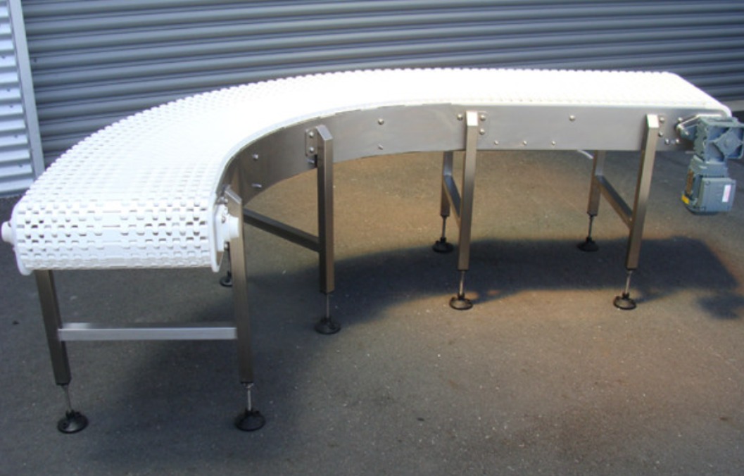 White modular conveyor belt material on a curved conveyor